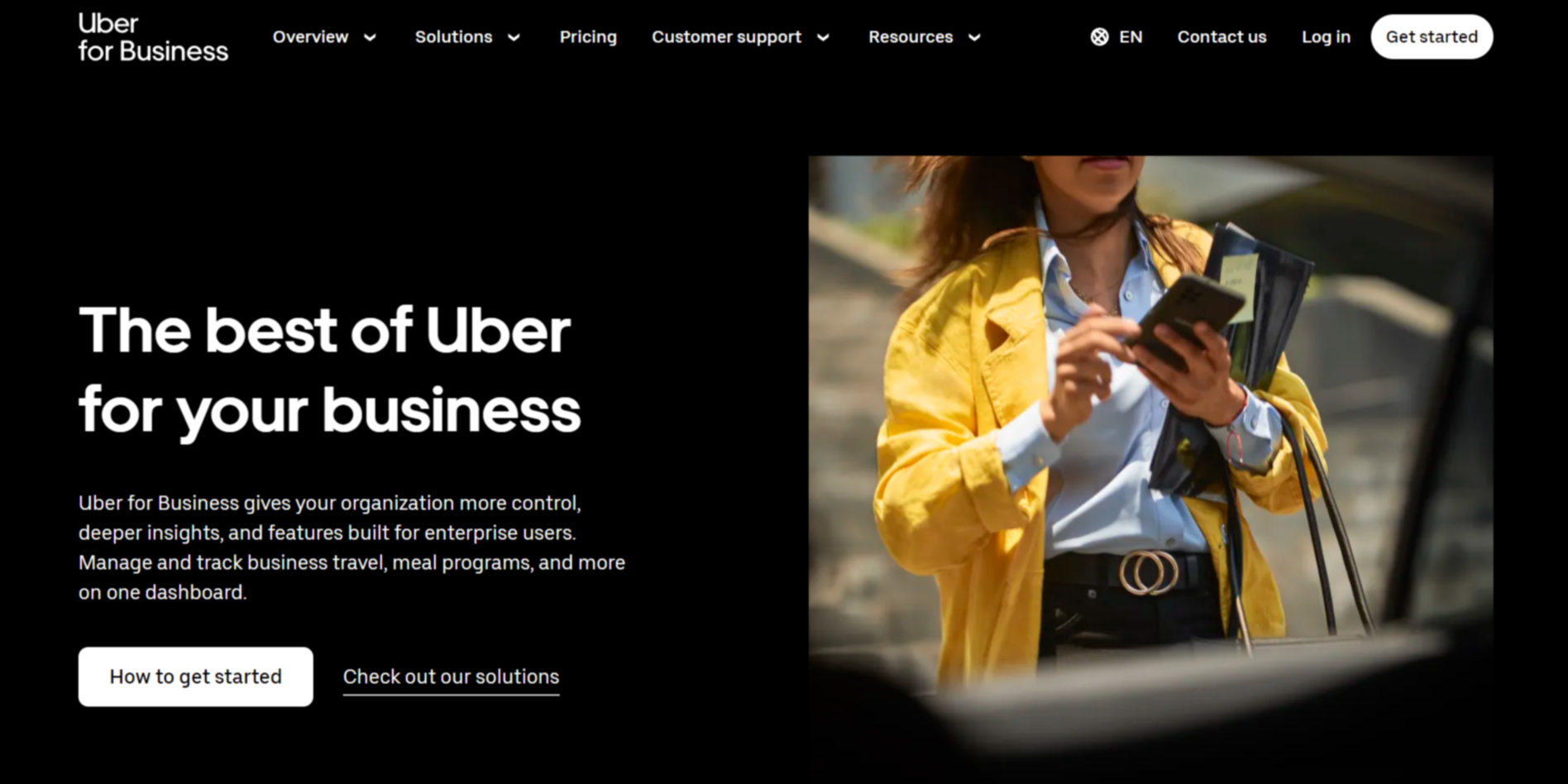 Landing page inspiration from Uber for Business with a black background, white font color, and an image of a person using their mobile phone.